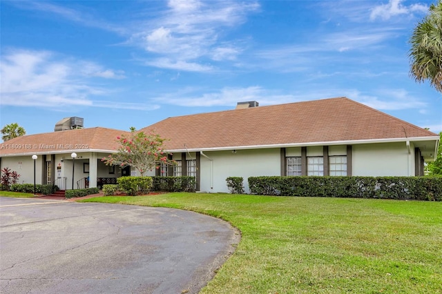 453 Lakewood Cir Unit A, Margate, FL 33063 - single story home with stucco siding, a front lawn, and a chimney