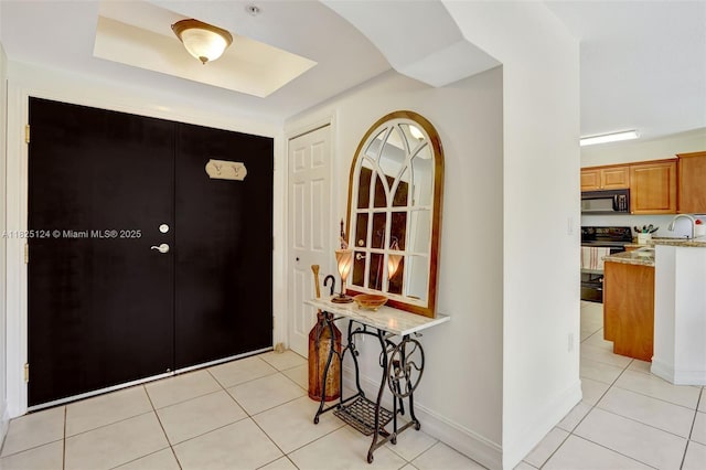 322 Madeira Ave Unit 402, Coral Gables, FL 33134 - foyer entrance featuring light tile patterned floors and a raised ceiling