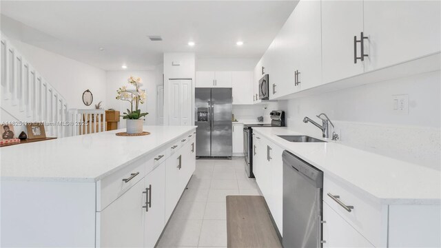 25564 SW 108th Ave, Homestead, FL 33032 - kitchen featuring stainless steel appliances, light countertops, a kitchen island, recessed lighting, and light tile patterned floors