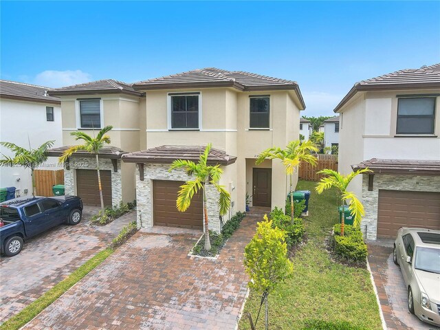 25564 SW 108th Ave, Homestead, FL 33032 - multi unit property featuring decorative driveway, an attached garage, stucco siding, and a tile roof
