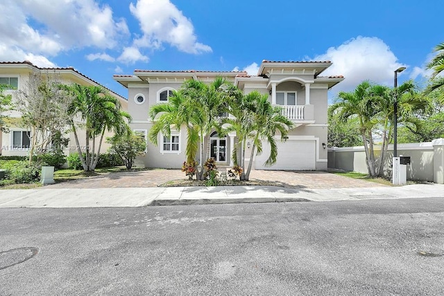 3521 Forest View Cir, Dania Beach, FL 33312 - mediterranean / spanish-style house with stucco siding, a balcony, a tile roof, and decorative driveway