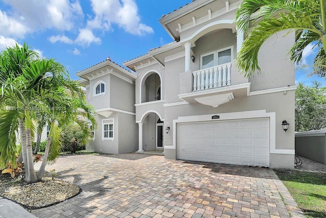 3521 Forest View Cir, Dania Beach, FL 33312 - mediterranean / spanish home with a balcony, a garage, stucco siding, and decorative driveway