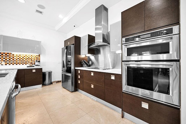 3521 Forest View Cir, Dania Beach, FL 33312 - kitchen with appliances with stainless steel finishes, island exhaust hood, backsplash, ornamental molding, and light countertops