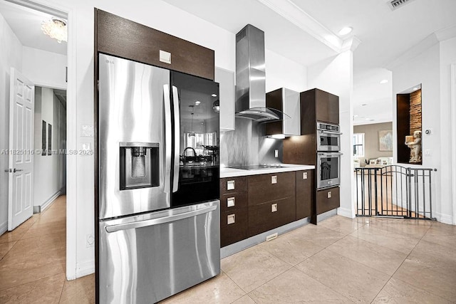 3521 Forest View Cir, Dania Beach, FL 33312 - kitchen featuring stainless steel appliances, island exhaust hood, light countertops, dark brown cabinetry, and light tile patterned floors