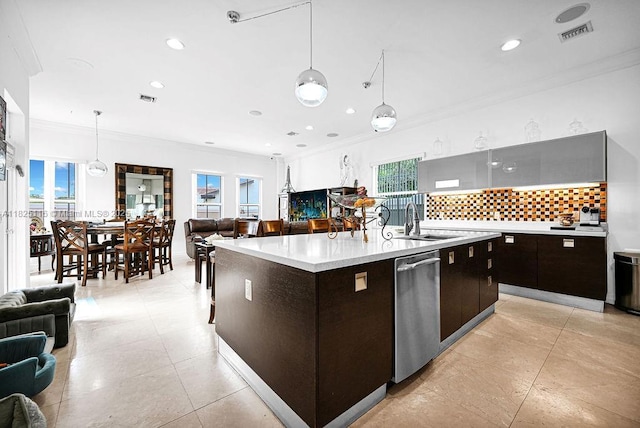 3521 Forest View Cir, Dania Beach, FL 33312 - kitchen with open floor plan, ornamental molding, dishwasher, decorative backsplash, and light countertops