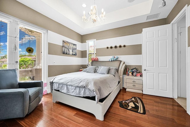 3521 Forest View Cir, Dania Beach, FL 33312 - bedroom featuring a chandelier, wood finished floors, and a raised ceiling