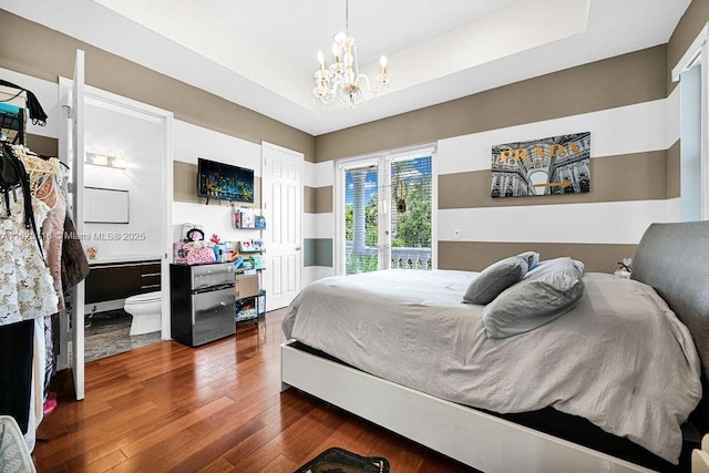 3521 Forest View Cir, Dania Beach, FL 33312 - bedroom featuring dark wood-style floors, a chandelier, a tray ceiling, and access to outside