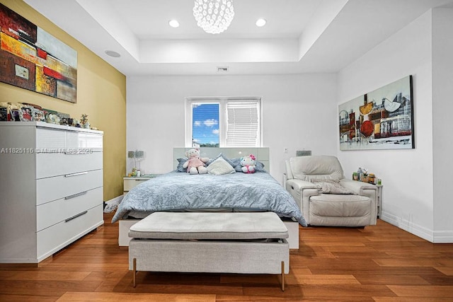 3521 Forest View Cir, Dania Beach, FL 33312 - bedroom featuring a raised ceiling, wood finished floors, recessed lighting, and a chandelier