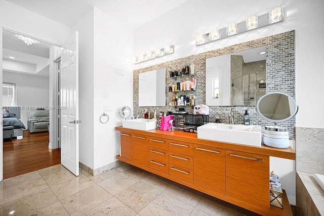 3521 Forest View Cir, Dania Beach, FL 33312 - bathroom with double vanity, connected bathroom, a shower stall, backsplash, and marble finish floors