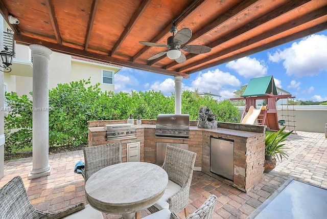 3521 Forest View Cir, Dania Beach, FL 33312 - view of patio with an outdoor kitchen, a ceiling fan, outdoor dining space, and a playground