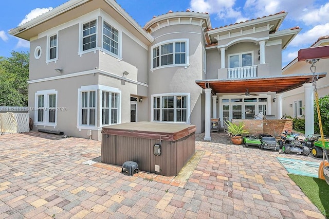 3521 Forest View Cir, Dania Beach, FL 33312 - back of property featuring a hot tub, a patio, a ceiling fan, and a balcony