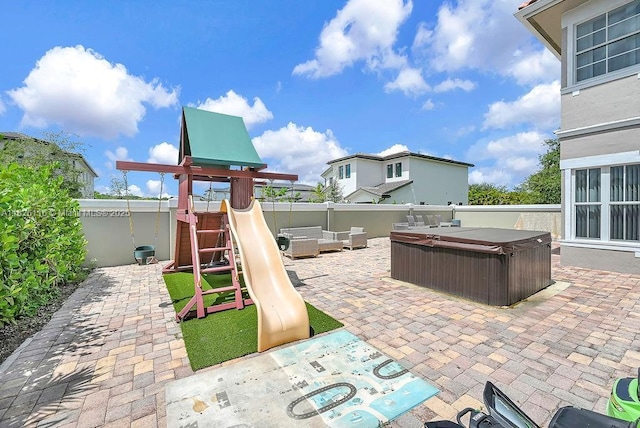3521 Forest View Cir, Dania Beach, FL 33312 - fenced backyard with a playground, a hot tub, and a patio area