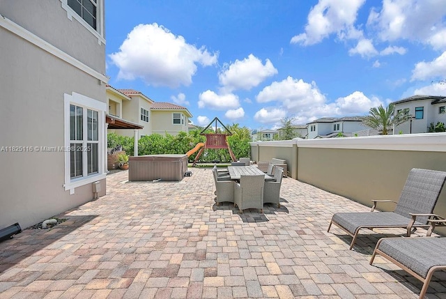 3521 Forest View Cir, Dania Beach, FL 33312 - view of patio / terrace featuring a playground, outdoor dining space, a residential view, and a hot tub