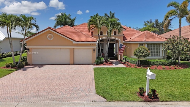 819 SW Bromelia Ter, Stuart, FL 34997 - mediterranean / spanish house featuring a garage, stucco siding, decorative driveway, a tiled roof, and a front lawn