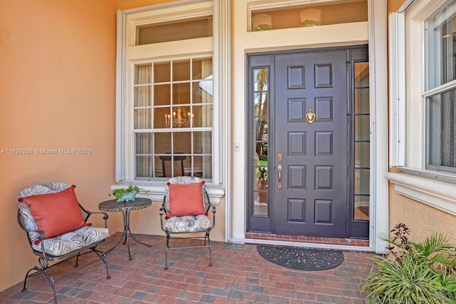 819 SW Bromelia Ter, Stuart, FL 34997 - property entrance featuring a porch and stucco siding