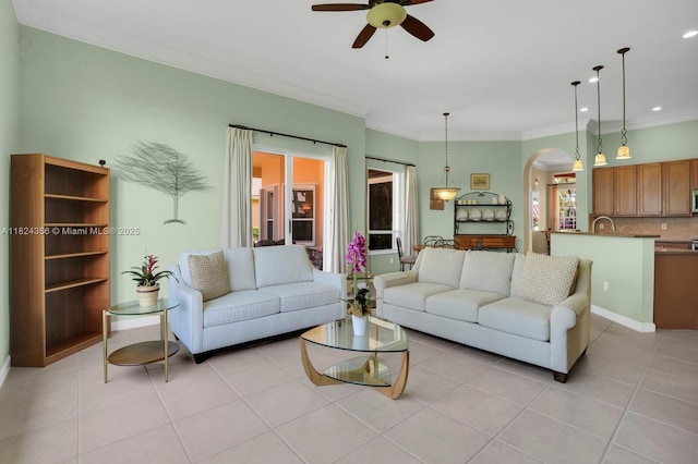 819 SW Bromelia Ter, Stuart, FL 34997 - living room with arched walkways, a ceiling fan, light tile patterned floors, ornamental molding, and recessed lighting