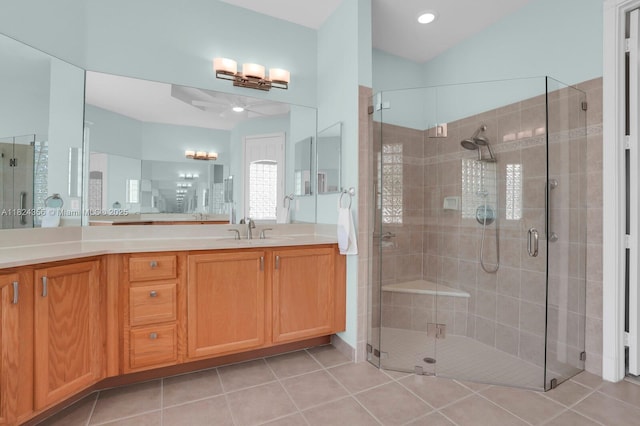 819 SW Bromelia Ter, Stuart, FL 34997 - bathroom with a ceiling fan, vanity, a stall shower, and tile patterned flooring