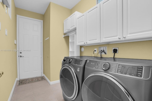 819 SW Bromelia Ter, Stuart, FL 34997 - washroom featuring cabinet space, washing machine and dryer, and light tile patterned floors