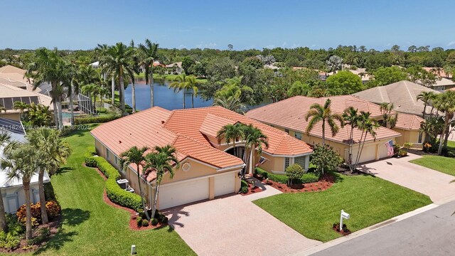 819 SW Bromelia Ter, Stuart, FL 34997 - aerial view of residential area featuring a nearby body of water and a tree filled landscape