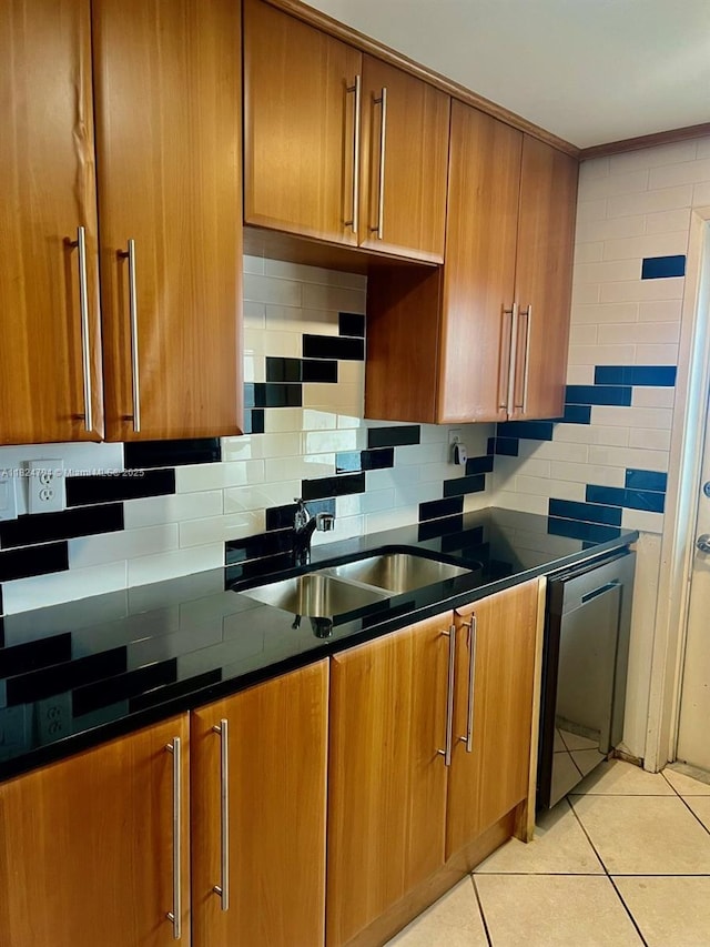 930 SE 9th Ave Unit 11, Pompano Beach, FL 33060 - kitchen featuring stainless steel dishwasher, brown cabinets, and tasteful backsplash