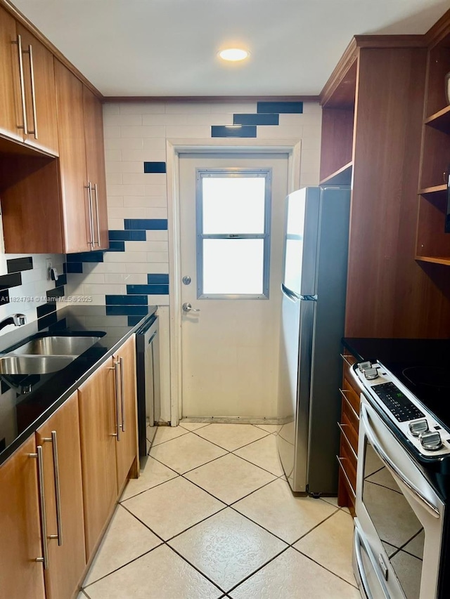 930 SE 9th Ave Unit 11, Pompano Beach, FL 33060 - kitchen with appliances with stainless steel finishes, open shelves, dark countertops, and brown cabinets