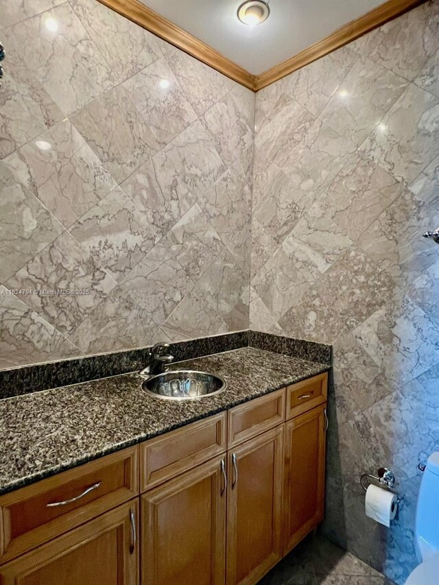 930 SE 9th Ave Unit 11, Pompano Beach, FL 33060 - bathroom featuring tile walls, vanity, and ornamental molding