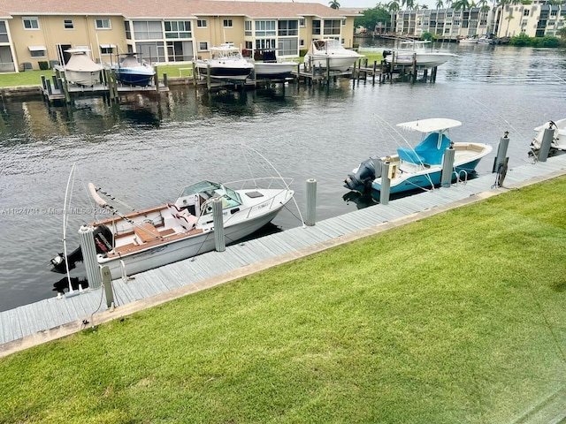 930 SE 9th Ave Unit 11, Pompano Beach, FL 33060 - dock with boat lift, a water view, a yard, and a residential view
