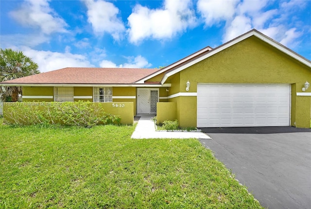 5610 NW 54th Ave, Tamarac, FL 33319 - view of front of property featuring stucco siding, a front yard, asphalt driveway, and an attached garage