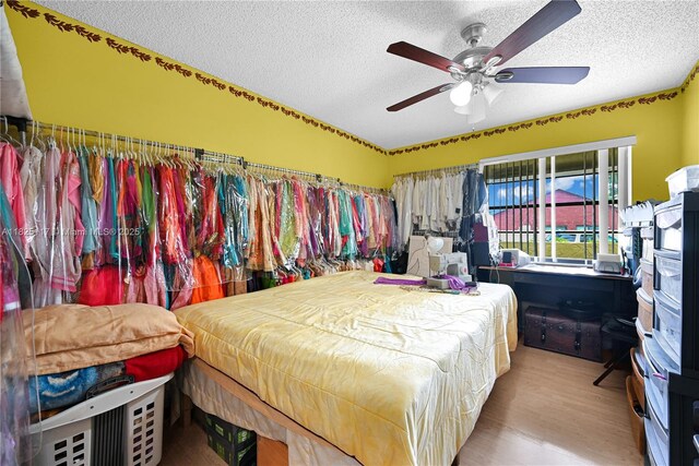 5610 NW 54th Ave, Tamarac, FL 33319 - bedroom featuring a textured ceiling, wood finished floors, and a ceiling fan