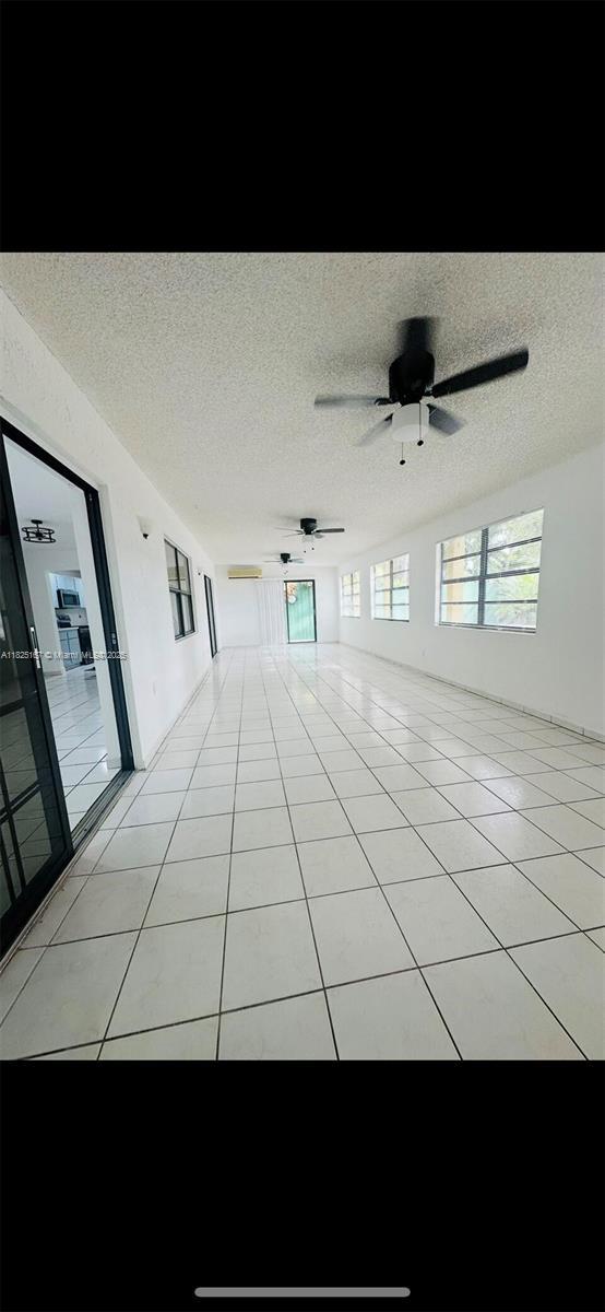9510 SW 151st Ct, Miami, FL 33196 - empty room featuring a ceiling fan, a textured ceiling, and light tile patterned flooring