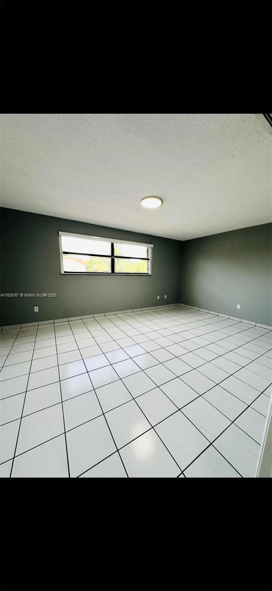 9510 SW 151st Ct, Miami, FL 33196 - empty room with a textured ceiling