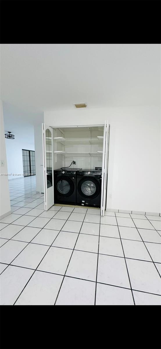 9510 SW 151st Ct, Miami, FL 33196 - washroom with separate washer and dryer and light tile patterned flooring