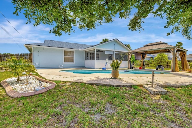 509 SW Hamburg Ter, Port St Lucie, FL 34984 - back of house with a sunroom, a gazebo, ceiling fan, and a patio area