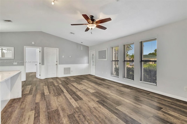 509 SW Hamburg Ter, Port St Lucie, FL 34984 - unfurnished living room featuring a ceiling fan, dark wood-style floors, and vaulted ceiling