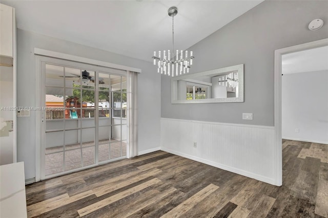 509 SW Hamburg Ter, Port St Lucie, FL 34984 - unfurnished dining area featuring wood finished floors, vaulted ceiling, a wainscoted wall, a chandelier, and a ceiling fan