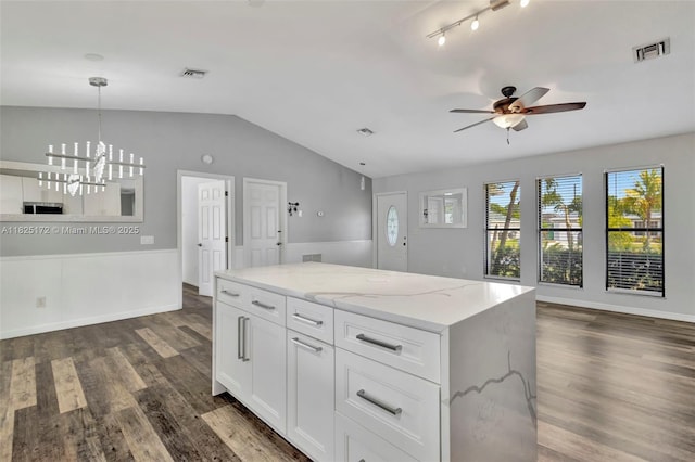 509 SW Hamburg Ter, Port St Lucie, FL 34984 - kitchen featuring vaulted ceiling, ceiling fan, open floor plan, dark wood finished floors, and light stone countertops