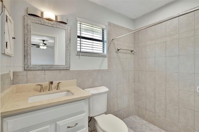 509 SW Hamburg Ter, Port St Lucie, FL 34984 - bathroom featuring vanity, a tile shower, tile walls, and ceiling fan
