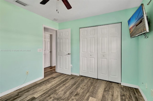 509 SW Hamburg Ter, Port St Lucie, FL 34984 - unfurnished bedroom with wood finished floors, a closet, and a ceiling fan