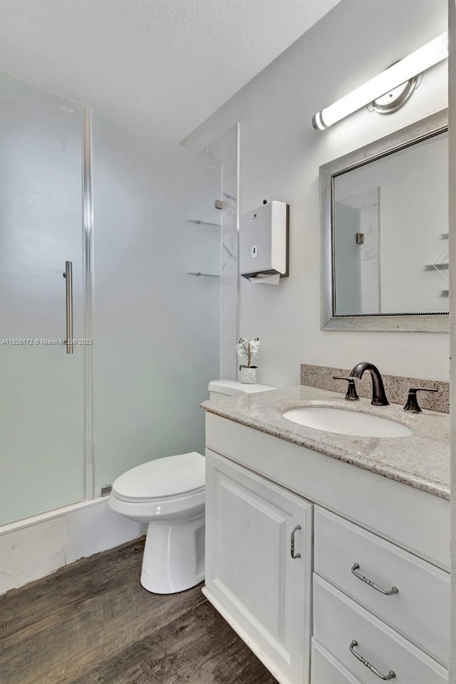 509 SW Hamburg Ter, Port St Lucie, FL 34984 - full bathroom with vanity, a shower stall, and wood finished floors