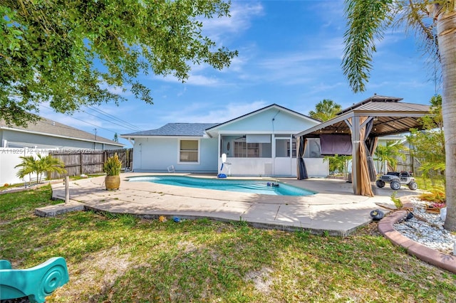 509 SW Hamburg Ter, Port St Lucie, FL 34984 - back of house with a sunroom, a gazebo, a patio area, and stucco siding