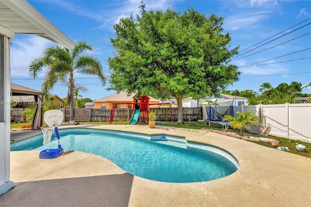 509 SW Hamburg Ter, Port St Lucie, FL 34984 - view of swimming pool featuring a playground, a fenced backyard, a gazebo, and a patio