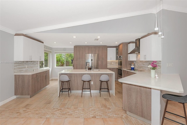 16859 Crestview Ln, Weston, FL 33326 - kitchen with wall chimney exhaust hood, appliances with stainless steel finishes, a breakfast bar, modern cabinets, and tasteful backsplash