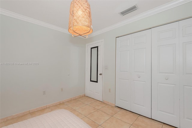 16859 Crestview Ln, Weston, FL 33326 - unfurnished bedroom featuring crown molding, a closet, light tile patterned floors, and a chandelier