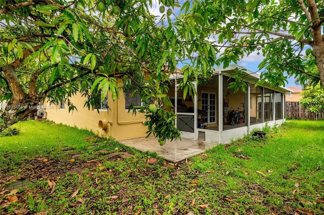 16859 Crestview Ln, Weston, FL 33326 - back of house featuring a sunroom, stucco siding, and a patio area