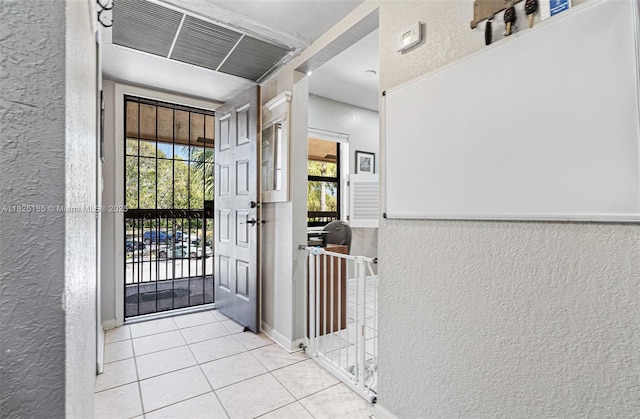 3059 S Carambola Cir S Unit 2330, Coconut Creek, FL 33066 - tiled entryway with a textured wall and healthy amount of natural light