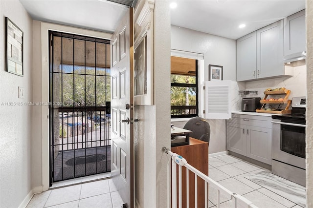 3059 S Carambola Cir S Unit 2330, Coconut Creek, FL 33066 - doorway featuring light tile patterned flooring, a textured wall, and recessed lighting