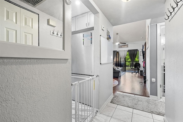 3059 S Carambola Cir S Unit 2330, Coconut Creek, FL 33066 - hall with tile patterned flooring and a textured wall