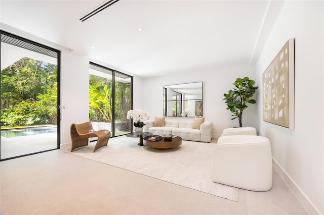 3670 Avocado Ave, Miami, FL 33133 - living room featuring baseboards and expansive windows