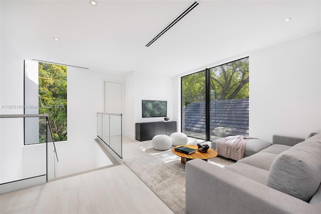 3670 Avocado Ave, Miami, FL 33133 - living area featuring healthy amount of natural light, a wall of windows, and recessed lighting