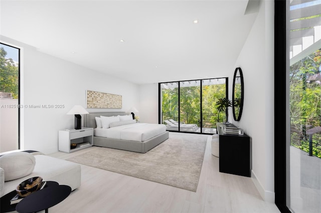 3670 Avocado Ave, Miami, FL 33133 - bedroom with multiple windows, access to exterior, wood finished floors, and expansive windows